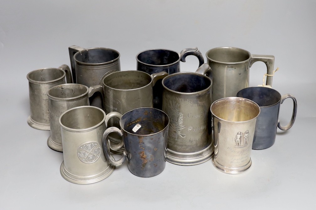 An Edwardian silver Kings company 204th prize Bisley 1904 commemorative beaker, 10cm and a collection of various pewter and plated shooting trophy mugs and tankards, Silver beaker 10 cms high.